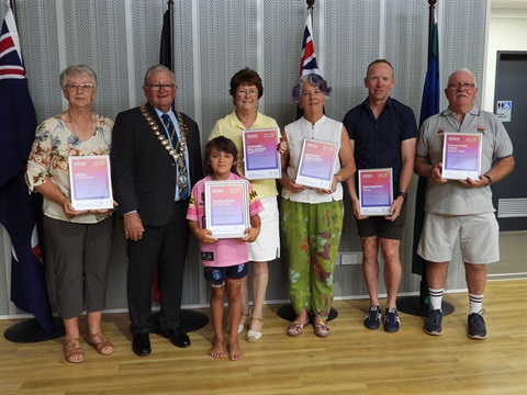 Group of people holding certificates