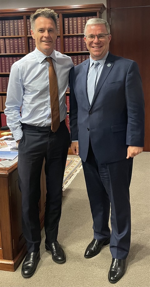Two men in suit standing side by side